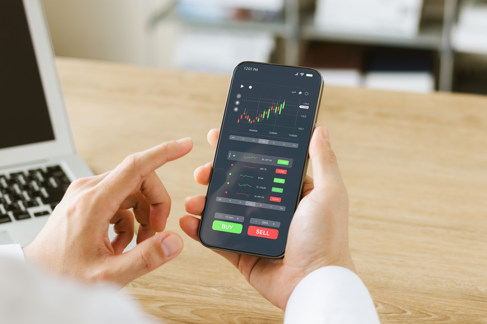 Businessmen work with stock market investments using smartphones to analyze trading data. smartphone with stock exchange graph on screen. Financial stock market.